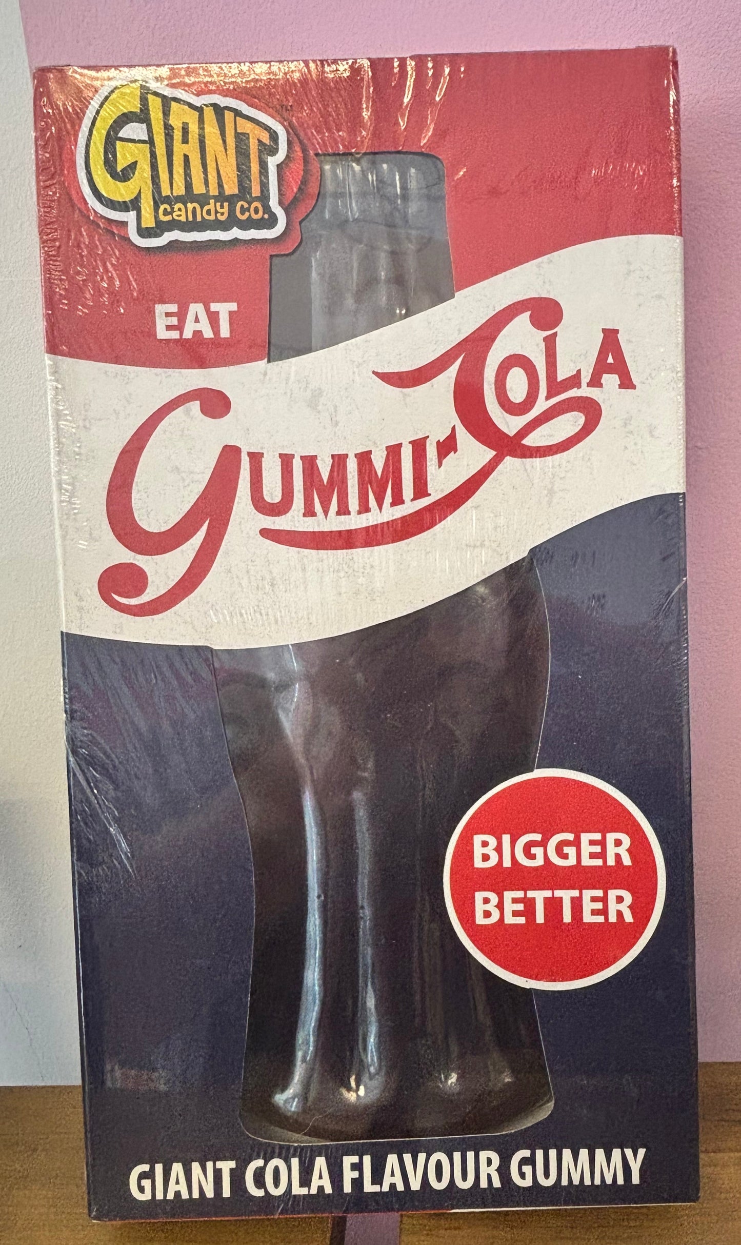 Gummy candy package with Cola flavor on a red white and blue surface
